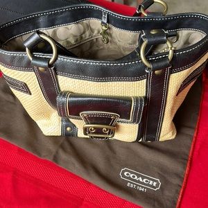 Beige coach purse with black straps. A summer like style with and texture.